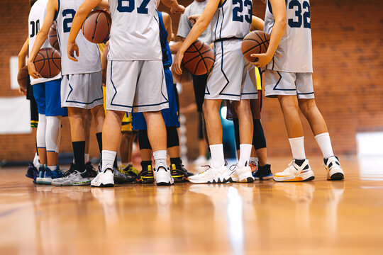 Strength in Unity: Basketball Team Huddling Together for Victory. Youth Players in Basketball Team Gathering During Break Time. Junior Level Basketball Players