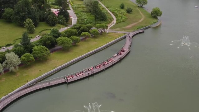 Aerial view of vacationers on a sun lounger on the pier on the lake promenade in summer
