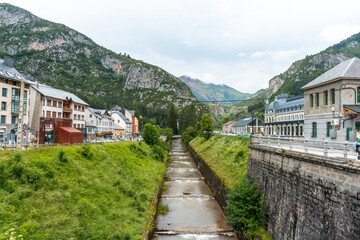 Fototapeta na wymiar View of the old train station of Canfranc in the Aragonese Pyrenees next to the river. Spain