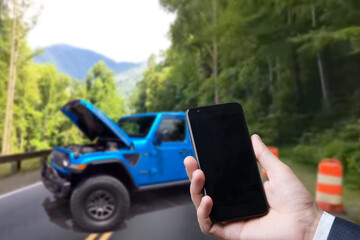 Man use mobile phone, blur image of the car is broken down as background.