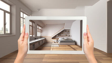 Augmented reality concept. Hand holding tablet with AR application used to simulate furniture and design products in empty interior with parquet floor, japandi bedroom