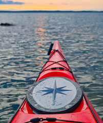 Red kayak in orange sunset over lake Vattern Motala Sweden