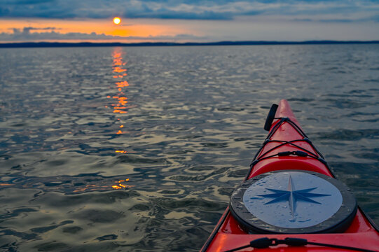 Red kayak in orange sunset over lake Vattern Motala Sweden