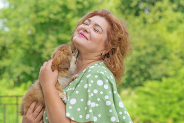 Woman with a little light brown puppy. Concept of human best friend