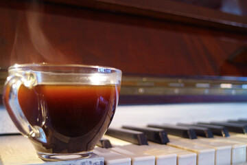 Closeup of a Cup of Hot Coffee with Smoke on the Piano