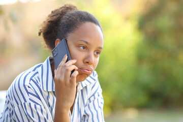 Impatient black woman complaining talking on phone