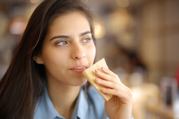 Restaurant customer cleaning mouth with paper tissue