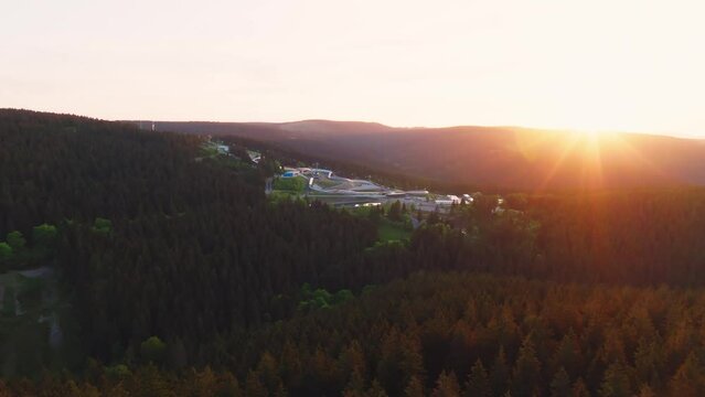 The Toboggan run in Oberhof in warm light in the evening. Drone move forward