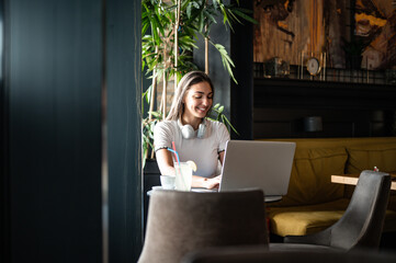 Young woman working remotely from caffe