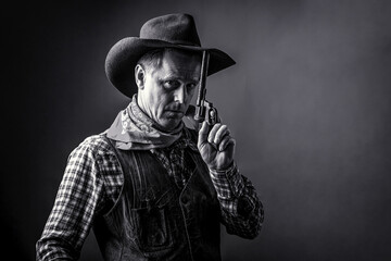 West, guns. Portrait of man wearing cowboy hat, gun. Portrait of a cowboy. American bandit in mask,...