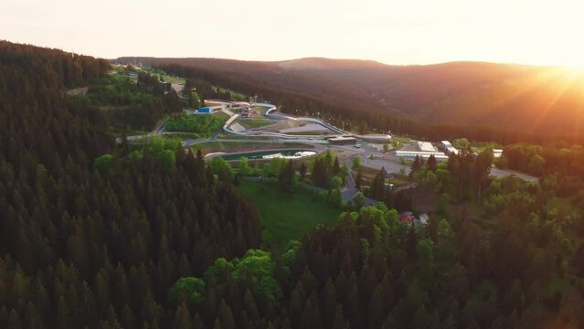 The Toboggan run in Oberhof in warm light in the evening. Drone move forward.