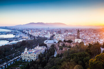 Obraz premium view over Malaga at sunset travel banner