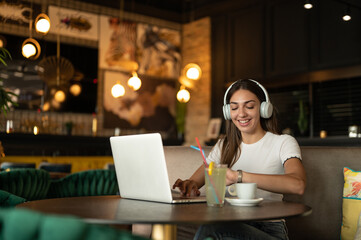 young woman working on laptop in cafe