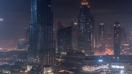 Fototapeta premium Aerial view of Dubai city all night timelapse in downtown.