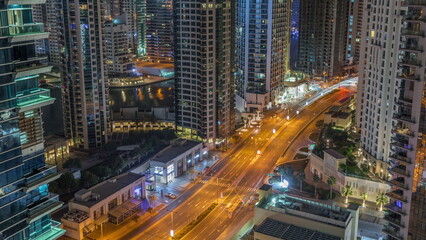 Fototapeta na wymiar Aerial view on Dubai Marina skyscrapers and the most luxury yacht in harbor night timelapse, Dubai, United Arab Emirates