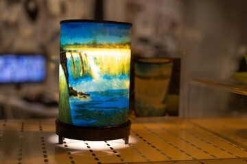 A lamp with picture of waterfall glowing