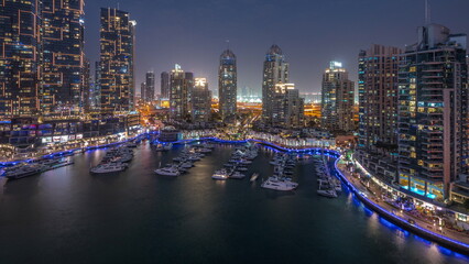 Fototapeta na wymiar Luxury yacht bay in the city aerial day to night timelapse in Dubai marina