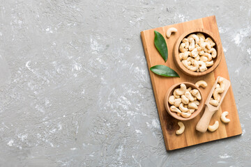 cashew nuts in wooden bowl on table background. top view. Space for text Healthy food