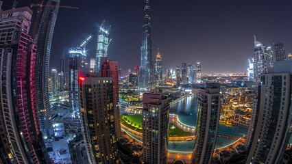 Fototapeta na wymiar Panorama of Dubai Downtown cityscape with tallest skyscrapers around aerial all night timelapse.