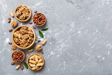 Walnut kernel halves, in a wooden bowl. Close-up, from above on colored background. Healthy eating Walnut concept. Super foods with copy space