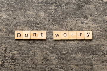 Don't worry word written on wood block. Don't worry text on cement table for your desing, Top view concept