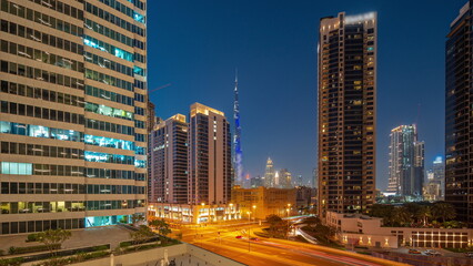 Fototapeta na wymiar Aerial panoramic view to Dubai downtown and difc skyscrapers day to night timelapse.