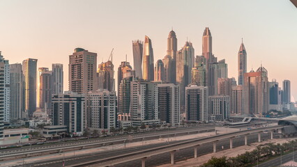 Fototapeta na wymiar Dubai marina tallest block of skyscrapers all day timelapse.