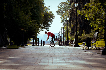 Ukrainian bmx rider performs tricks in the middle of the city.