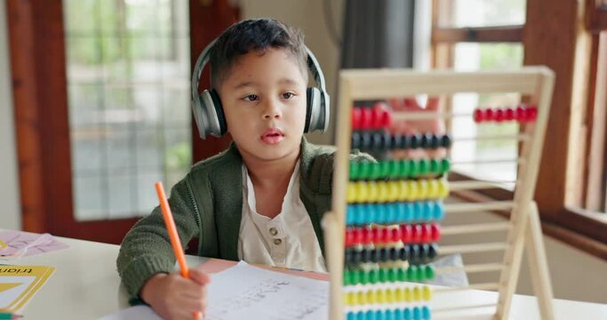 Home learning, math education or child in kindergarten studying for knowledge or growth development. Abacus, headphones or smart kid writing or counting on numbers to study for test in notebook