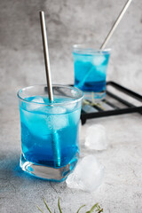 A glass of cocktail, Blue Lagoon. cool. on a gray background