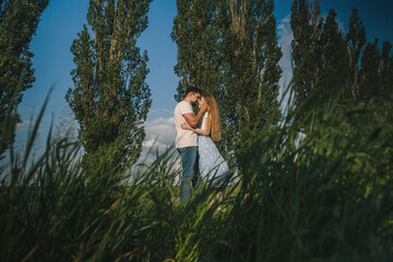 Far away view of a couple in love want to kiss on the background of nature. True love among lovers. Sincere emotions and love on the planet.