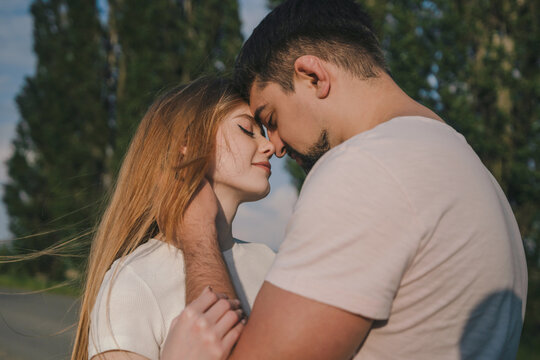 Portrait of a amazing couple embracing and face to face close with closed eyes wanting to kiss in their vacation time. Happy family, summer, vacation.