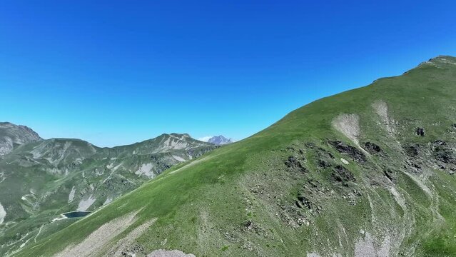 Rotating drone shot of a mountain peak in the Mercantour national park