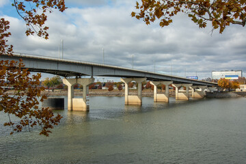 View of the Main Street Bridge over Arkansas River with colorful fall trees in downtown Little Rock, Arkansas, USA