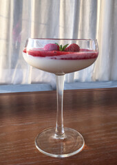 ice cream, dessert in a tall glass with raspberries and cream