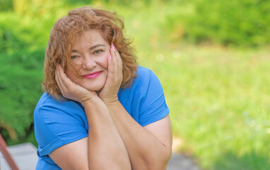 Plus size nice lady 50-55 years old dreaming about something positive and smiling. Psychology oа...