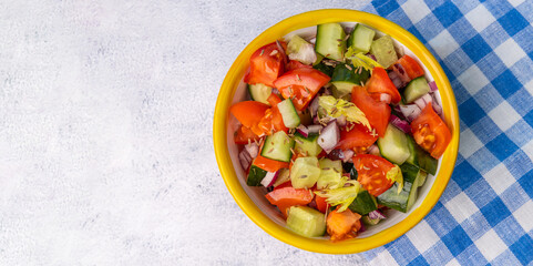 Kachumber Salad is the Indian cucumber, tomato, and onion salad, top view. This is a fresh, easy chopped salad with cumin or cumin seeds. The vegetables are dressed with lemon juice and salt.