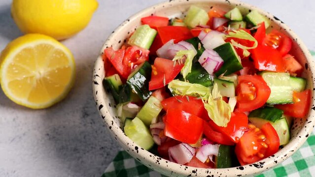 Kachumber Salad is the Indian cucumber, tomato, and onion salad. The vegetables are dressed with lemon juice and salt. girl bowl a plate on the table a fresh, easy chopped salad with cumin or cumin 