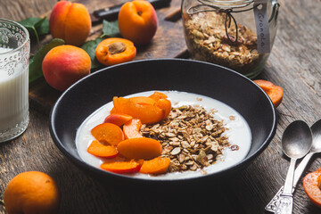 Granola with yogurt and apricots in a bowl