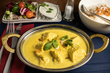 A bowl of Chicken Korma in an Indian restaurant.