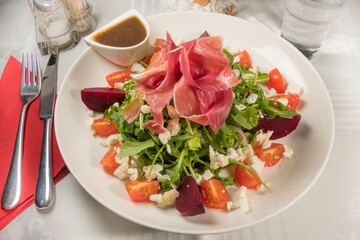Chevre cheese salad with ham, dressing and beets.