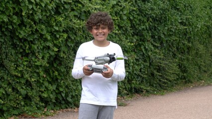 Boy kid 9 years old play and flight with drone - dreaming to fly in childhood  - learn to children...