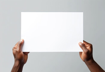 hands are holding a blank sheet of paper with a white background - 624345939
