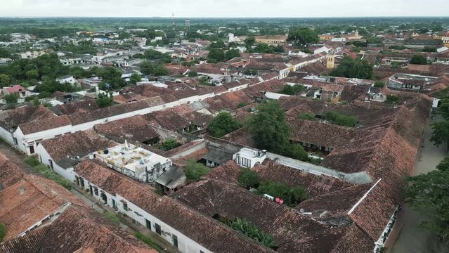 Aerial above Santa Cruz de mompox colonial town village with traditional old architecture buildings in Colombia Bolivar department drone fly above city center historical 
