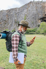 independent traveler with backpack lifestyle checking smart phone online