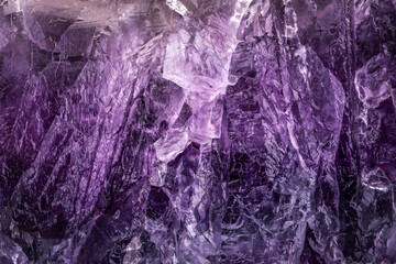 fluorite (also called fluorspar) purple macro detail texture background. close-up raw rough unpolished semi-precious gemstone.