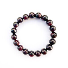 Garnet crystal bracelet on white background.Energy crystals. Healing gemstones
