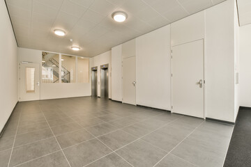 an empty office space with white walls and grey flooring, there is no one door on the right side