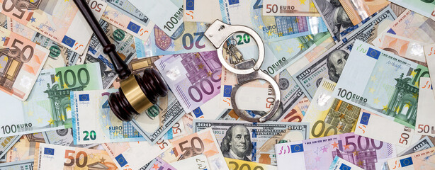 crime concept - handcuffs, gavel dollar and euro bills