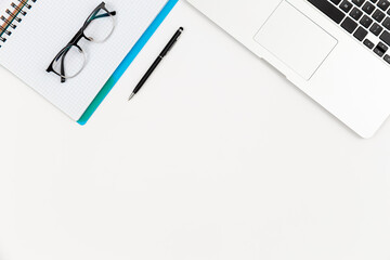 Notebook, glasses, pen and laptop on a white background isolated.